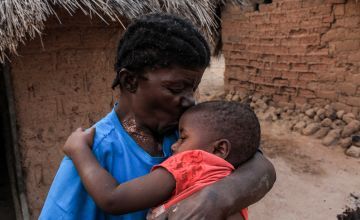 Caustasie (61) kisses her grandson Emmanuel (1) who survived a acute malnutrition thanks to a health centre supported by Concern Worldwide Kiambi village in the DRC