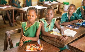 Two schoolgirls in Sierra Leone at their desks
