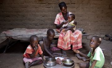 South Sudanese woman at home with her four children