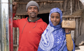 Couple outside their home in Ethiopia