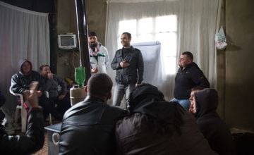 A group of Syrian refugee men in a meeting in Lebanon