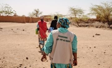 Three women walking in Niger with backs to camera