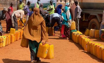 A Somali woman walks to Concern's water truck to fill up her containers for her family in Odweyne in the Toghdeer district where water sources have dried up due to drought. Photo: Concern Worldwide