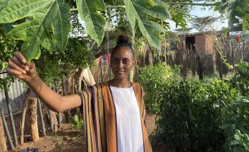 Young woman in a kitchen garden in Kenya