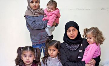 Syrian refugee woman with her five children in Lebanon
