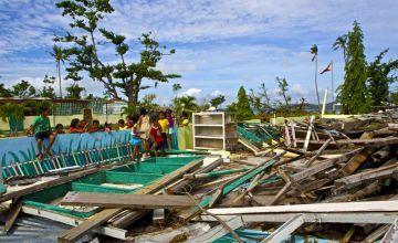 Schoolchildren look at their destroyed classroom in Polopina, Philippines in the wake of Typhoon Haiyan, 2014.