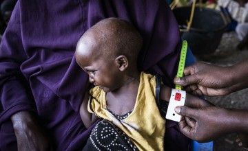 Child being measured for malnutrition