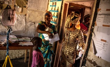 Nurse in the DRC holding an infant