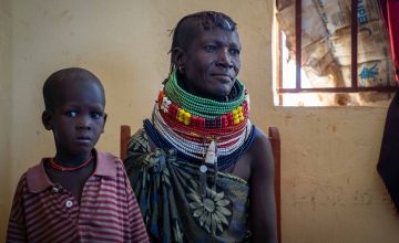 A woman sits with her son at a malnutrition clinic in Kenya