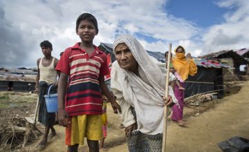 Young boy and grandmother in Rohingya refugee camp, Bangladesh