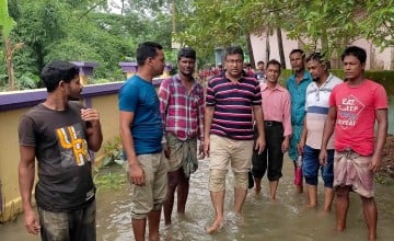 Zillur Rahman Chowdhury walking in water, Bangladesh. Photo: Concern Worldwide