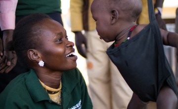 A woman screens a baby for nutritional development in Aweil North, South Sudan