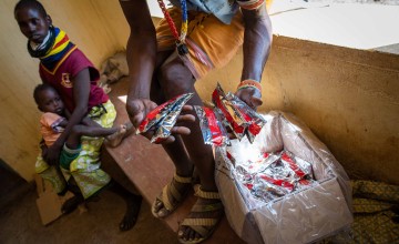 Ready-to-use therapeutic food (RUTF) is handed out to parents of children with malnutrition at a clinic in northern Kenya's Turkana province