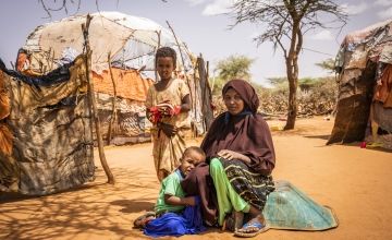 Somali mother with two of her children in their village