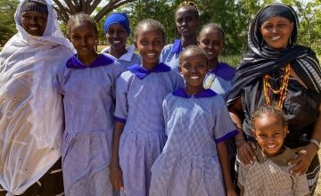 Kenyan schoolgirls with the local businesswomen who sponsor their education