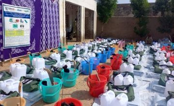 Rows of buckets, water jugs and foods
