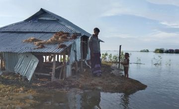 Bangladeshi family examines their house following the 2022 floods