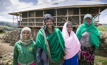 Ethiopian farmer Ali Assan and his family standing outside their home in South Wollo, Ethiopia