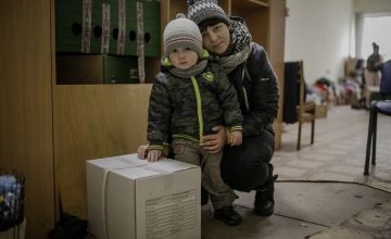 Darina and her son, Petro with their food kit in Ukraine
