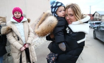 Ukrainian refugees entering Romania at a border crossing.