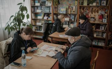 People wait to be verified so that they can receive a cash transfer from the JERU programme in Ukraine. Photo: Simona Supino/Concern Worldwide