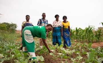 Concern staff member Jane Mughogho with four farmers in crop patch in Malawi