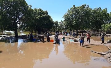Women washing laundry in floodwater caused by Cyclone Freddy