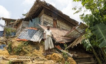 Man standing in front of damaged shelter in Bangladesh