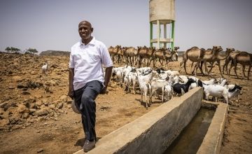 A man standing next to an irrigation project in the desert region of Somaliland