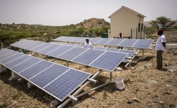 Somali men inspect a solar panel system as part of an irrigation project in Somaliland
