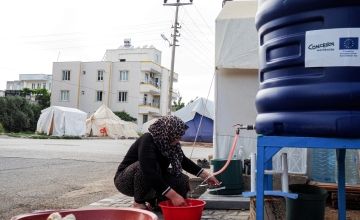 Amneh fills a container at a water tank that was provided by Concern Worldwide Photo: Yasin Almaz/Concern Worldwide