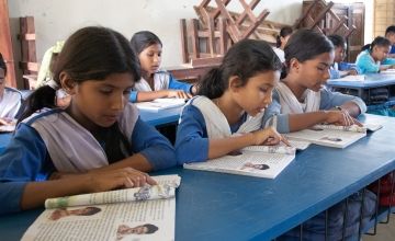 Young Bangladeshi girls study their books in primary school