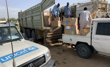 Staff unloading truck of medical supplies