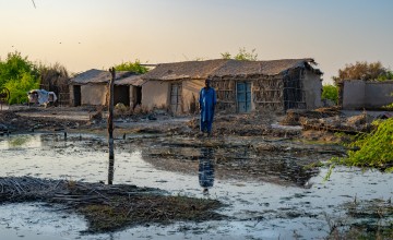 Man standing among damage caused by Pakistan floods