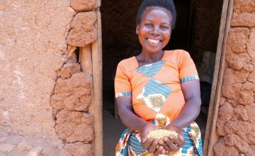 Marie-Claire with a handful of soya beans that she has harvested from her land and will sell to her neighbours.
