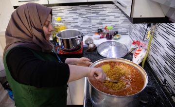 Concern staff member stirring pot of food in Turkiye