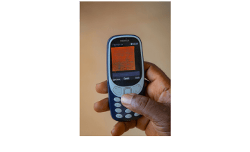 Mobile phone being held in hand