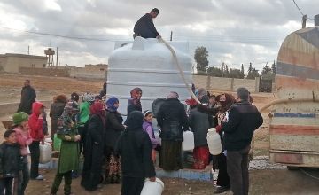 Displaced Syrian families congregate at a water truck, which Concern fills with clean water regularly.