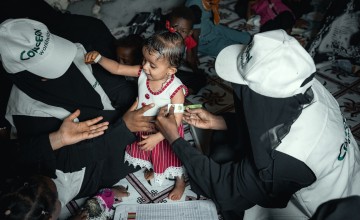 Community Health Volunteer (CHVs) conducting nutrition screening on a child in Yemen.