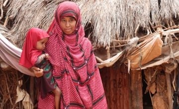 Nurto Mohamud Mohamed holds her daughter, Anfa in their home in Dollo, Ethiopia