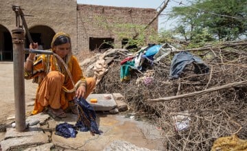 Nusrat, Maula Dinno's wife, washes her children's clothes outside their home in Sindh. (Photo: Zoral Khurram Naik/DEC/Concern Worldwide)