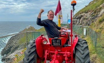 Pat Murphy looking back with the Mizen light house in the background having completed his trek for Concern and Gaza