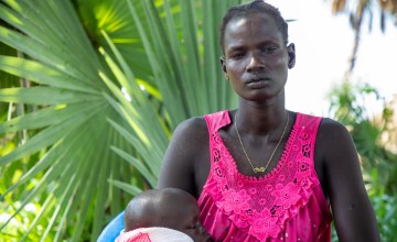 Maria with her son, Goi (2), outside their home in Leer County, Unity State, South Sudan. Photo: Eugene Ikua/Concern Worldwide 