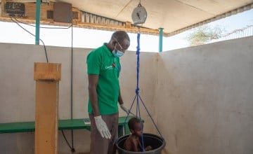 Abdul Alhadji (5) gets weighed at the Concern health post in Baga Sola, Western Chad. (Photo: Eugene Ikua/Concern Worldwide)