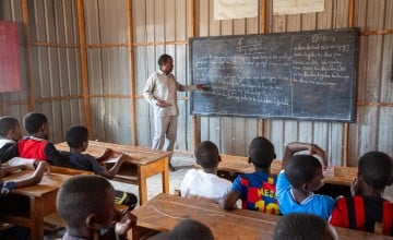 Anas* teaches at Tokyo school which is located in an Internally displaced camp and supported by Concern. Anas* recalls how the people in the camp had issues with reading whenever they get phone messages or papers but now that the children attend classes they help adults read. (Photo: Mustafa Saeed/Concern Worldwide)