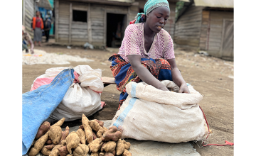 After participating in a Concern training on income-generating activities and receiving cash assistance, Furaha now has a prosperous business in wholesale and retail where she sells potatoes in her village market in Ndobogo, DRC. (Photo: Ariane Rwankuba/Concern Worldwide)