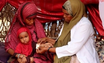 Mother-to-mother support groups play a vital role in enhancing breastfeeding practices and reducing child wasting. At this session in Dollo, Ethiopia, Nurto Mohamud Mohamed learns to monitor her daughter, Anfa's, nutrition with MUAC tape. (Photo: Adan Mohamed Afar/Concern Worldwide)