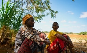 Hassan Ali and Adam Mohamed take a break from working their fields in Bardhere District. (Photo: Concern Worldwide)