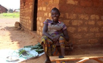 Tiyassi Joanette sits outside her home in Central African Republic on a sunny day