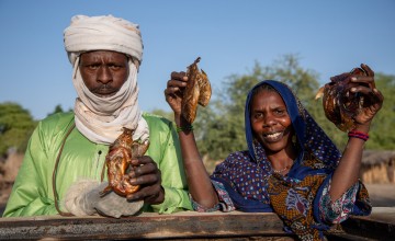 Mahamat (left), Vice President of the Fishing Association, with Aicha, standing at the brick smoke house, constructed by Concern.